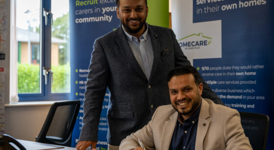 Image of two recent Kare Plus franchisees signing their agreement.